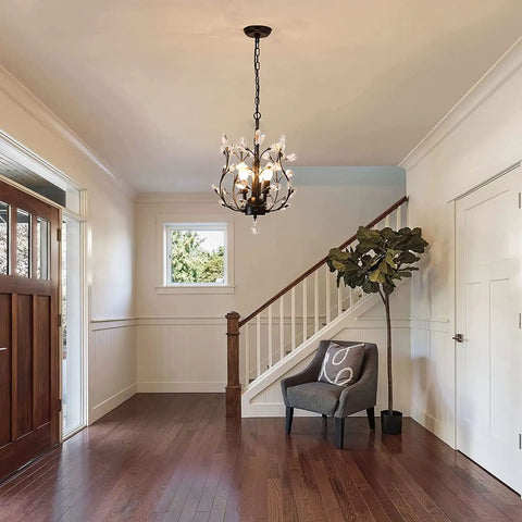 Vintage K9 Clear Crystal 3-Light Pendant Ceiling Fixture In Black Finish hanging in a modern foyer with a staircase.