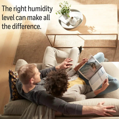 Couple reading on sofa with text 'The right humidity level can make all the difference.'