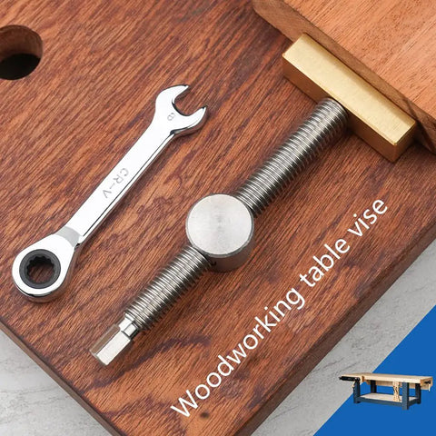 Top Shelf Heavy Duty Brass And Aluminum Workbench Vice For Woodworking Tables Featuring Rust Resistant Stainless Steel Jaws Compact Fit Wide Grip Setup Real Deal secured on wood surface with wrench.