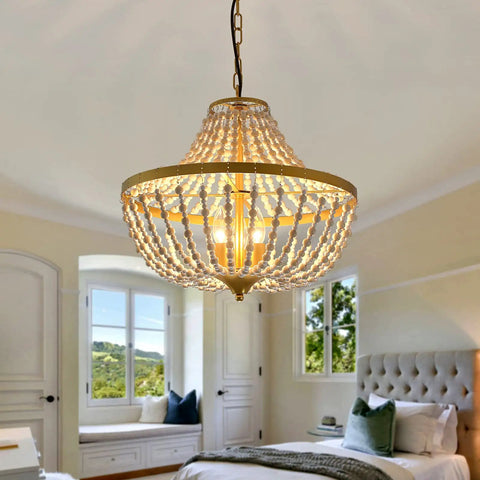 Three Light Boho Wood Beaded Gold Chandelier for Rustic Farmhouse Style Pendant Light Fixture hanging in bedroom.