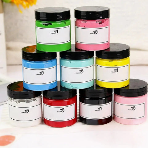 12 Pack 4 Oz Clear Plastic Sample Jars With Heavy Duty Black Screw Top Lids Super Portable Travel Cosmetic Storage Containers stacked with colorful contents.