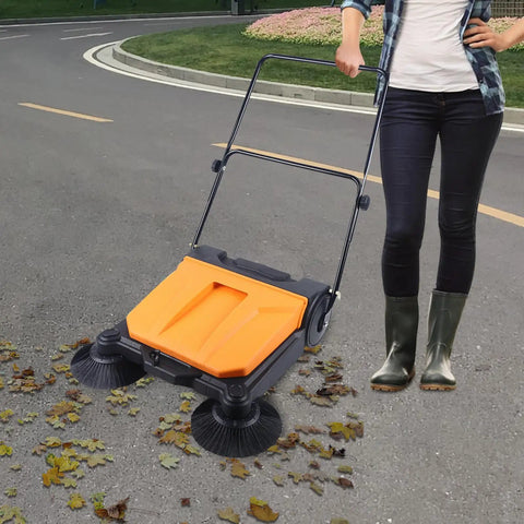 Heavy Duty 26 Inch Walk Behind Floor Sweeper With Foldable Handle And Sturdy Nylon Brushes For Durable Home Garage Cleaning Use No Electricity Needed Easy Maneuver Sweep in use on outdoor pavement.