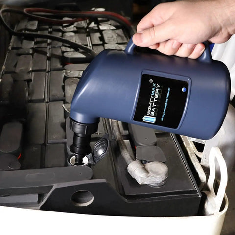 Auto Shut Off Battery Filler Jug For Golf Carts And Deep Cycle Batteries in use, showing black nozzle in battery cell opening.