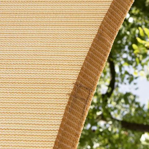 Close-up of beige 10 by 16 foot rectangle shade sail for patio garden and backyard blocks 95 percent UV rays, double-stitched edge detail.