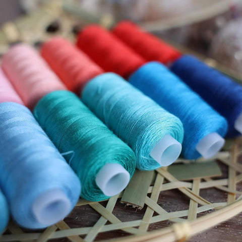 Top Shelf 72 Piece Sewing Thread Kit With 36 Vibrant Polyester Shades And Matching Bobbins showing colorful spools of thread.