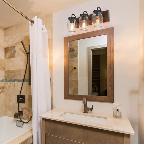 Farmhouse Mason Jar Bathroom Vanity Lights With Faux Wood Backplate In Warm Brown Finish above a bathroom mirror