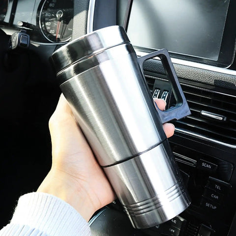 Zero Drama 12V And 24V Ride Along Electric Kettle Straight For Your Center Console Food Grade Steel Vessel held in hand inside car.