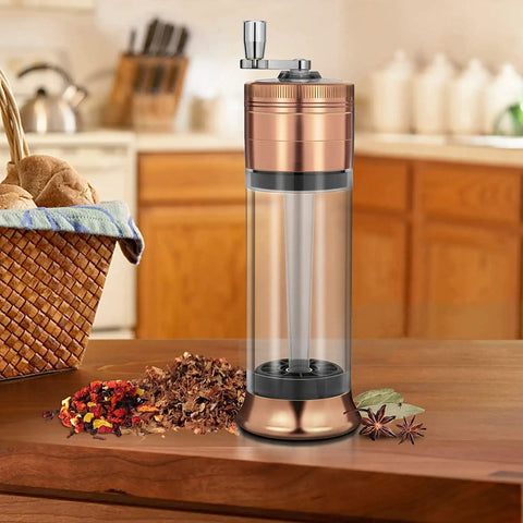 3-In-1 Spice Grinder With Hand Crank, Roller Crusher And Cone Filler on kitchen counter with spices, clear viewing chamber shown