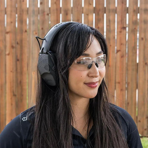 Woman wearing Electronic Hearing Protection Earmuffs NRR 22 DB Rating for safety in a shooting range environment.