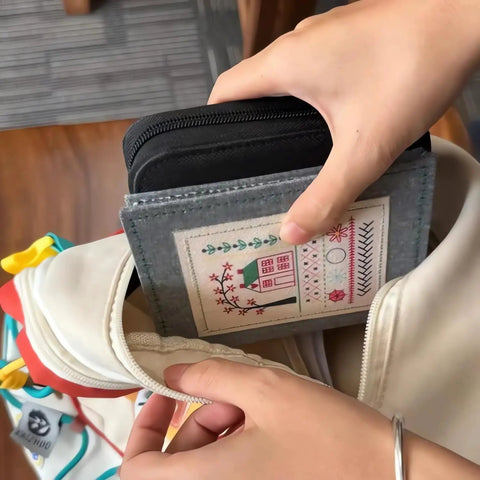 Person placing 2026 Upgraded Embroidery Stitch Book Kit With 106 Grab And Go Patterns into a craft bag pocket, portable size visible.