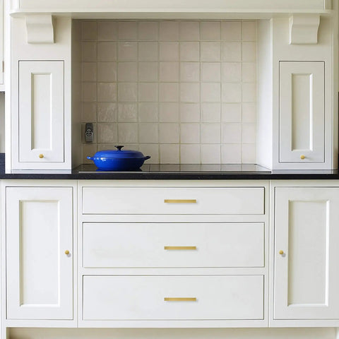 Dope Brushed Brass Cabinet Knobs 10 Pack For Modern Kitchen Hardware Handles installed on white cabinets in a kitchen