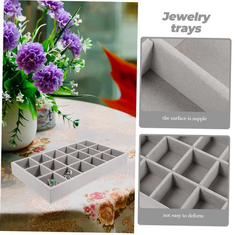 Three Piece Multi Grid Jewelry Organizer Trays Featuring Earring Stands Necklace Display Plates And Soft Velvet Ring Inserts To Make Sorting Your Bling A Breeze For Home Or Showroom Use on a table with floral decoration.