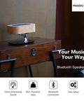 Masdio Bedside Lamp With Bluetooth Speaker And Wireless Charger on wooden desk, featuring cherry wood shade and modern design.