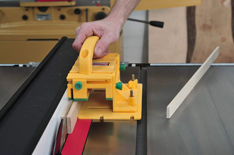 Grr-Rip Block 3D Pushblock System for Table Saws in use, guiding narrow wood stock, yellow with gravity heel on a saw table.