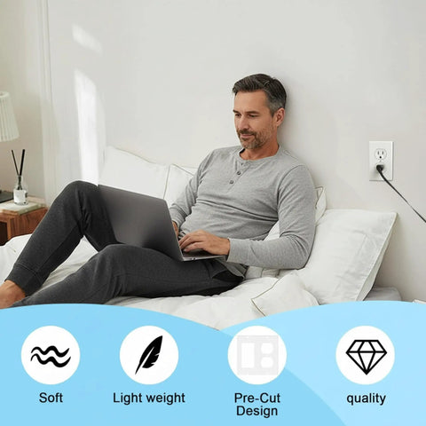 Man using laptop on bed beside outlet with Universal Foam Outlet Insulation Pads And Draft Sealer Gaskets 30 Pcs displayed