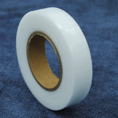 Double Sided Iron On Hemming Tape Fusible Bonding Web For Garment Repair And Crafting on a dark blue fabric background.