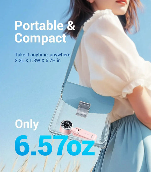 Portable Handheld Turbo Fan With 5 Gear Wind, Battery Operated, Up To 12 Hours Run Time inside a clear handbag outdoors