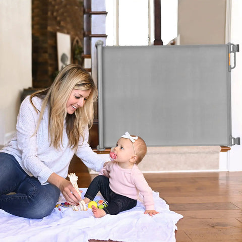 Mother with baby in front of Retractable Mesh Baby Gate For Stairs And Doorways, Extra Wide Up To 71 Inches, 33 Inches Tall, Double Lock Safety Gate