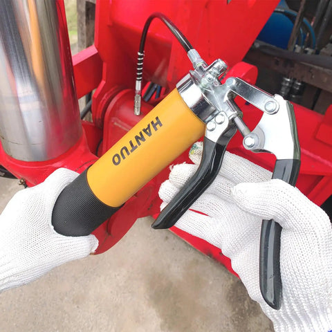Person using Heavy Duty 8000 PSI Grease Gun Kit With Quick Release Coupler And One Hand Friendly Ergonomic Grip on machinery.