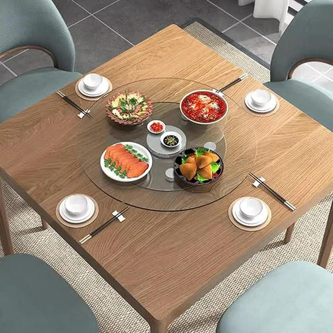 Premium Tempered Glass Lazy Susan Turntable Serving Tray For Dining Tables And Party Crews Featuring Silky Swivel Spin And No Sweat Washup At Thirty Four Inches Across on a wooden table with various dishes.