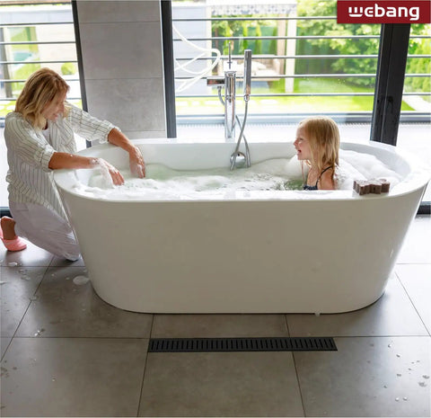 Mother and daughter enjoying bath near 24 Inch Linear Shower Drain With Capsule Pattern Cover Grate, Rectangular Floor Drain In Matte Black SUS304 Stainless Steel, Removable Cover, CUPC Certified, No Hub Compatible, No Fuss Install, High Flow Drainage, Anti Clog Tech. in modern bathroom