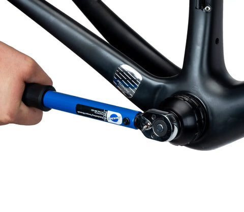 12-Notch Bottom Bracket Tool For Praxis M30, Three Eighths Inch Drive Ratchet Compatible being used on a bicycle frame.