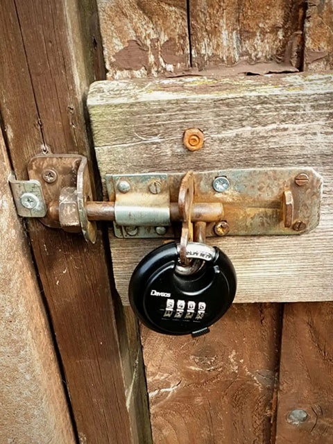 Rugged Outdoor Combination Disc Padlock With Four Digit Code Heavy Duty Weatherproof Rustproof Lock For Storage Units Gates Fences And Trailers Black Three Eighth Inch Shackle on wooden gate