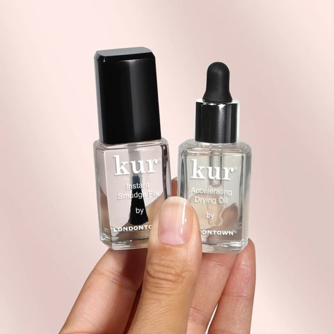 Instant Smudge Fix For Nails Smooths Dents And Imperfections Quick Dry Top Coat Booster Prime Manicure Glow Up Pack in hand.