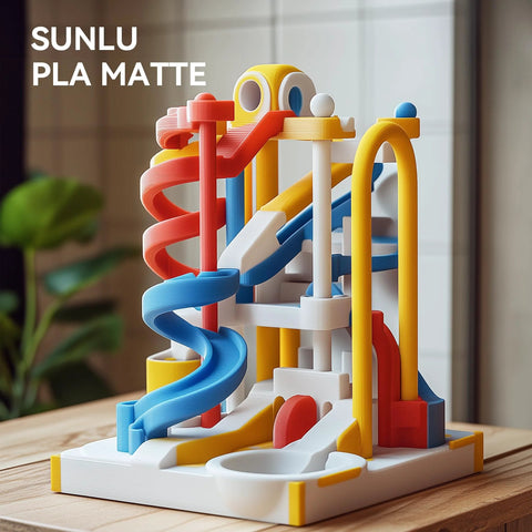 Front view of a colorful marble-run toy with red, blue, yellow spirals on a white base.