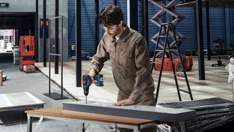 Man using Badass Cordless Screwdriver Equipped With High Capacity Li Ion Battery And Rapid Charger for DIY project at workshop.