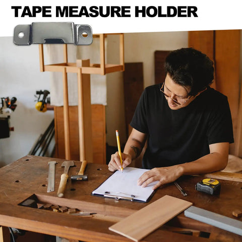 Badass Rock Solid Metal Tape Measure Holder Belt Clip And Pocket Tool Holster With Secure Rivets For Leather Aprons Contractor Pants And Denim Jeans Black on a woodworking table.