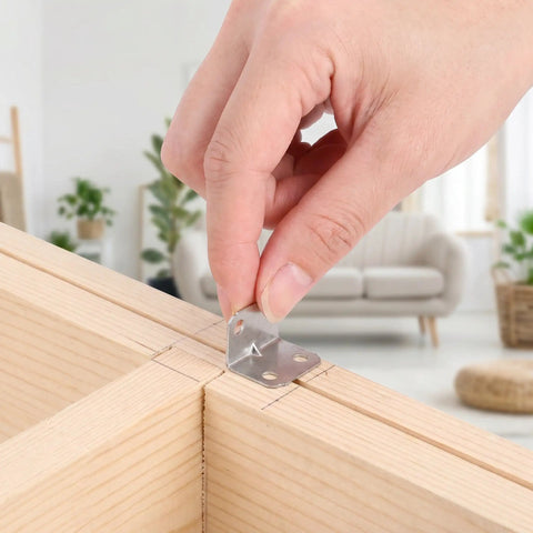 Hand installing Heavy Duty L Brackets For Wood Framing, Cold Rolled Steel Corner Braces, 100 Pack, 90 Degree Right Angle Supports