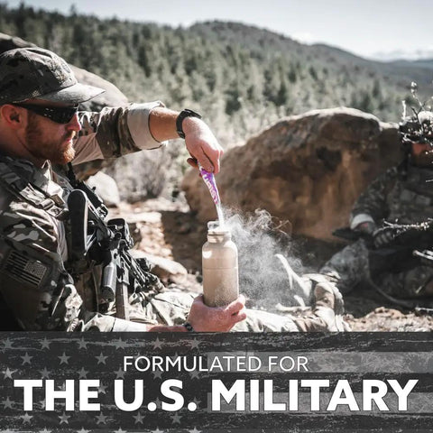 Sick Electrolyte Drink Mix Powder Sticks Loaded With Vital Minerals For Crushing Workouts And Fast Post Gym Recovery Peach Mango Flavor being mixed in a bottle by a military personnel.