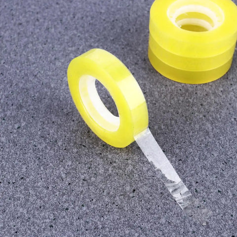 Dope 12 Pack 11mm X 30m BOPP Packing Tape, transparent roll on grey surface, easy to cut and refill, strong adhesive visible