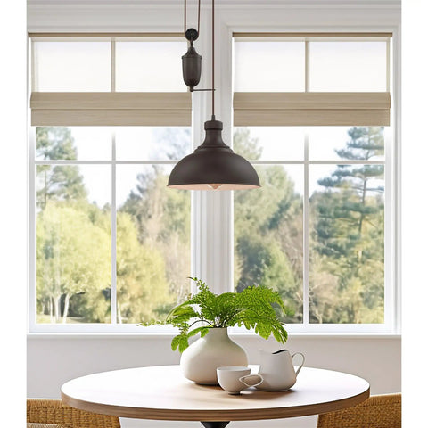 Sequoia 13 Inch Dope Industrial Pulley Pendant Light With Dome Shade And Counterweight In Oil Rubbed Bronze over round table.