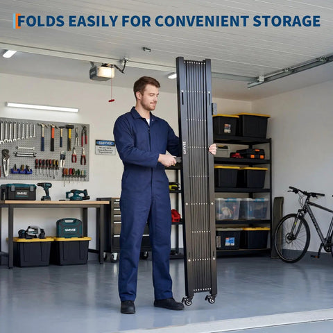 Man holding Secure Your Zone With This Beast Mode Heavy Duty Expandable Security Gate, showcasing its foldable design and casters.