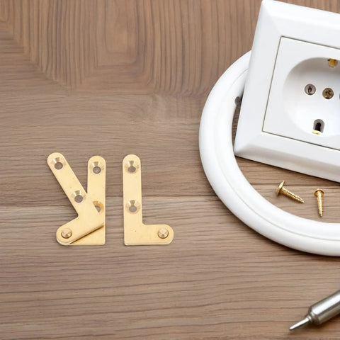 Four Piece Hidden Pivot Door Hinges For Windows And Metal Doors, Brass Finish, placed beside white socket on wooden surface