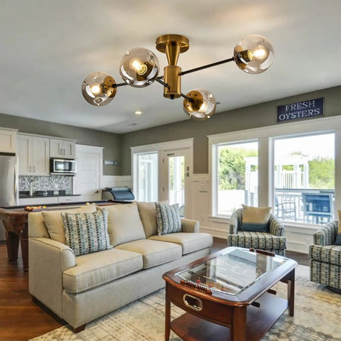 Modern Four Light Gold Glass Globe Ceiling Light Fixture in living room with semi flush mount and rustic vibe.