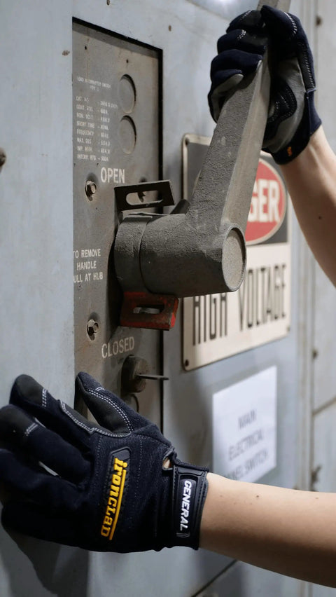 Person wearing General Utility Spandex Work Gloves Black Large Pair with padded palm operating high voltage equipment lever.