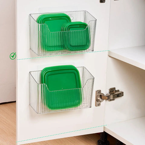 2 Pack Self Adhesive Cabinet Door Organizer Stackable Hanging Storage Bins holding green lids in clear bins inside kitchen cabinet.