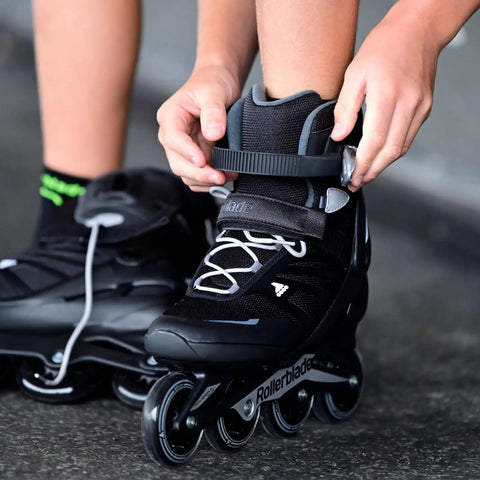 Person fastening Zetrablade Inline Skates For Men Starter Fitness Skates with High Cuff Support Durable Shell, black and silver.
