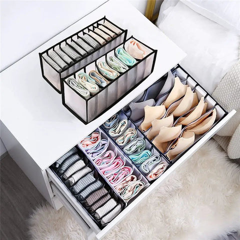 Slick Nylon Mesh Drawer Divider Set For Bras Socks And Lingerie Dresser Sorting Bins displaying organized bras and socks in a nightstand drawer.