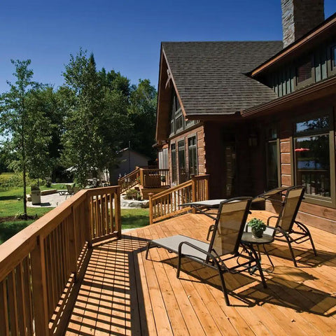 Outdoor wooden deck with chairs, built using PrimeGuard Plus Premium Deck Screws For Outdoor DIY Projects.