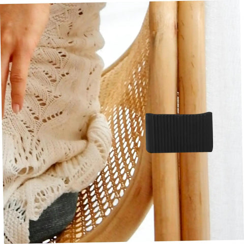 Black easy-install clamp on rattan chair with hand showing stability. Outdoor Sectional Sofa Clips 4 Pack For Patio Furniture.