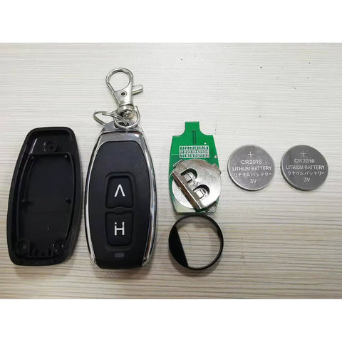 Key fob with open case, two CR2016 lithium batteries, metal keyring, flat surface