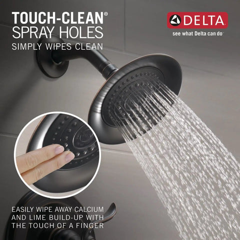 Windemere 14 Series Shower Faucet Set in oil rubbed bronze spraying water, showing Touch-Clean spray holes for easy cleaning.