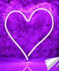 Heart Shape LED Neon Light Sign 13.4 Inch Wall Hanging Neon Vibe Decor For Bar Bedroom Living Room Dorm Party Home Use USB Powered 5V Night Light With On Off Switch glowing against purple flowers