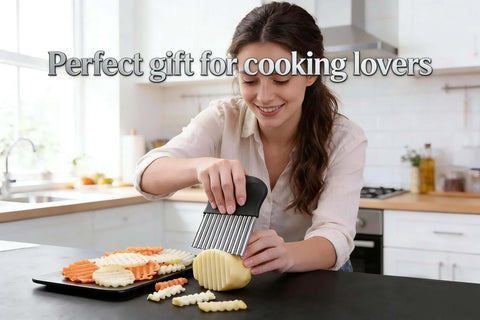 Front view of French fry slicer with large crinkle cutter, black handle, stainless steel blade slicing potatoes.