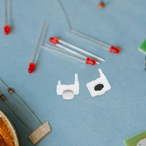 Close-up of 40 Piece Silicone Push Button Switch Replacement Keypad Membrane For Home Diy Repair, durable white silicone switches on a blue background.