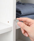 Hand inserting Beefy Spoon Shape Metal Shelf Pegs 60 Pack 7mm Nickel Plated Shelf Pins for kitchen cabinets and closets